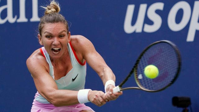 Article thumbnail: FILE - Simona Halep, of Romania, returns a shot to Daria Snigur, of Ukraine, during the first round of the U.S. Open tennis championships Aug. 29, 2022, in New York. Halep was dropped from the U.S. Open field on Monday, Aug. 21, 2023, because of a provisional doping suspension. (AP Photo/Seth Wenig, File)