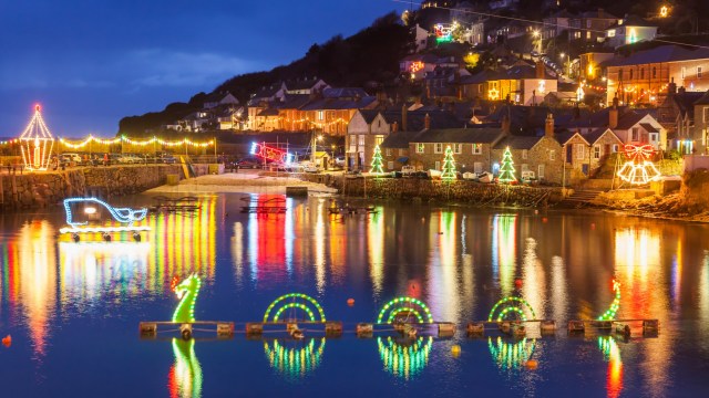 Article thumbnail: Beautiful display of Christmas Lights at Mousehole Harbour Cornwall England UK Europe